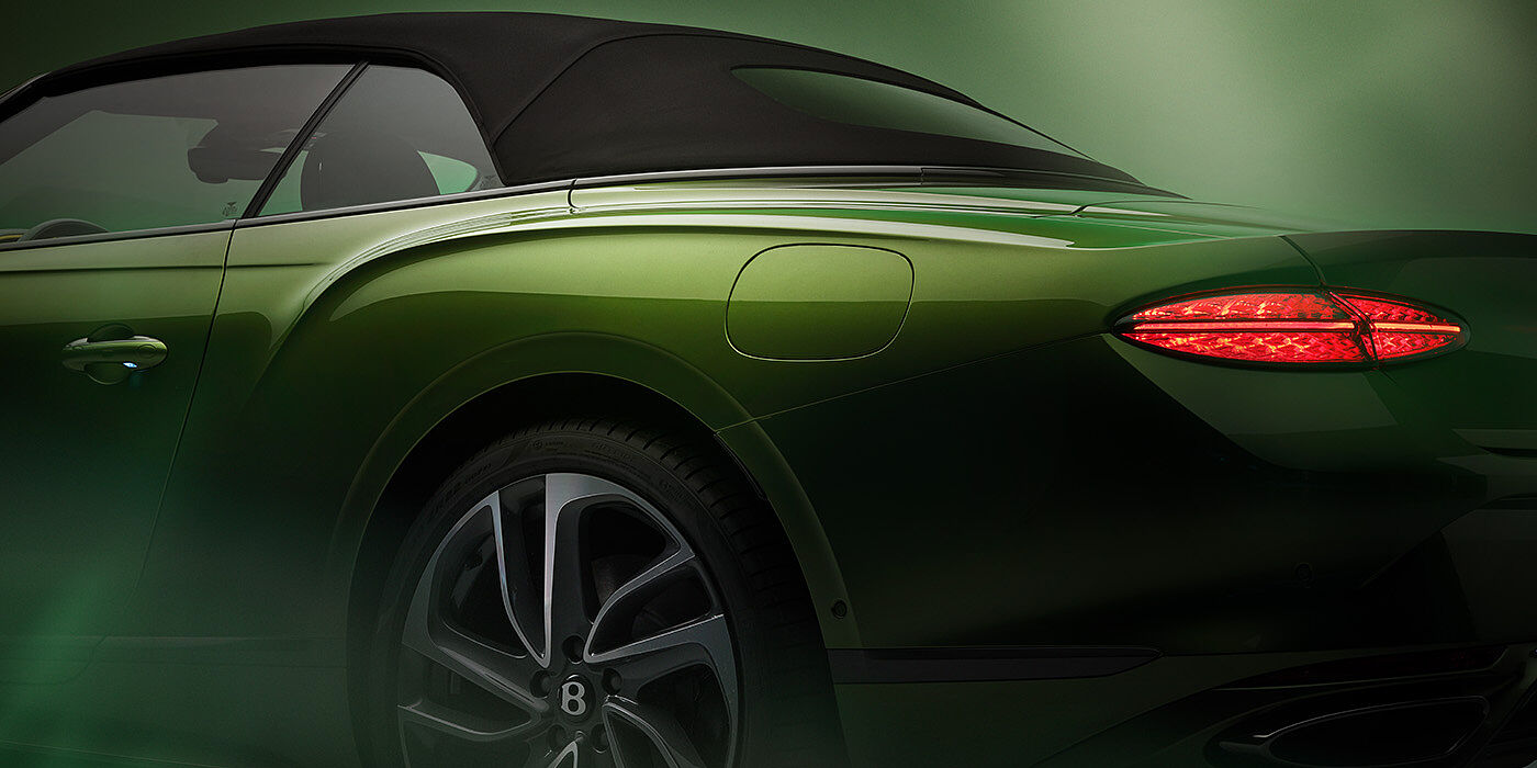 Bentley Kyiv Bentley New Continental GTC Speed rear haunch and tail lamp in Tourmaline Green paint and dark tint brightware with black hood up and illuminated head lamps