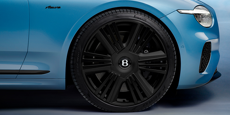 Bentley Kyiv New Bentley Continental GTC Azure convertible front wheel detail with 22 inch black ten spoke wheel and dark chrome details against Light Windsor blue paint